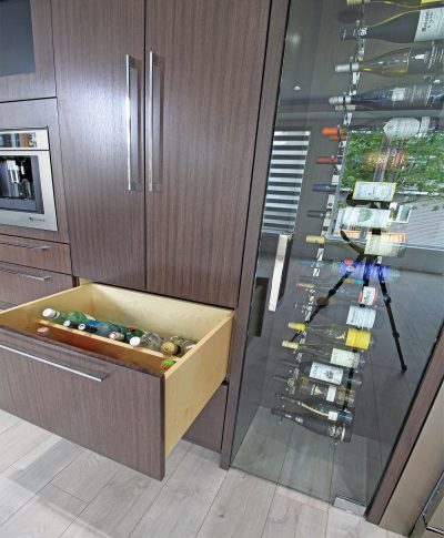 This set of custom cabinets comes with everything including a convenient drawer located beside your built in wine cooler that houses all of your spirits too ... and built for easy viewing!